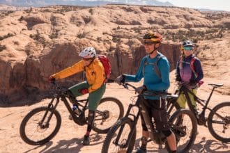 Happy guests enjoying the views on Best of Moab Mountain Bike tour with Escape Adventures