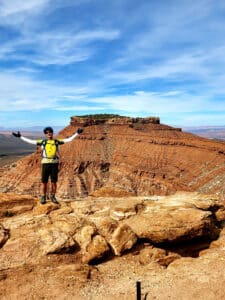 A guest posing with a breathtaking view from Gooseberry mountain bike tour | Escape Adventures