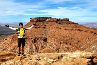 A guest posing with a breathtaking view from Gooseberry mountain bike tour | Escape Adventures