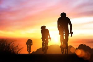 Road cyclists in silhouette
